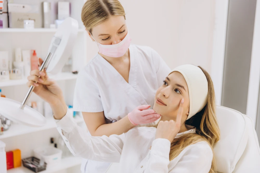Woman consulting with a med spa professional about facial treatment.